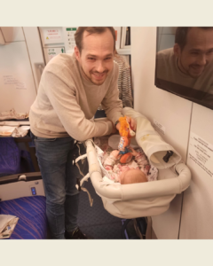 Elsa in bassinet seat on the plane